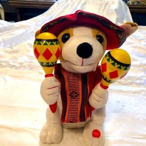 Dog in poncho, a sombrero-Santa hat, with Mariachi Maracas